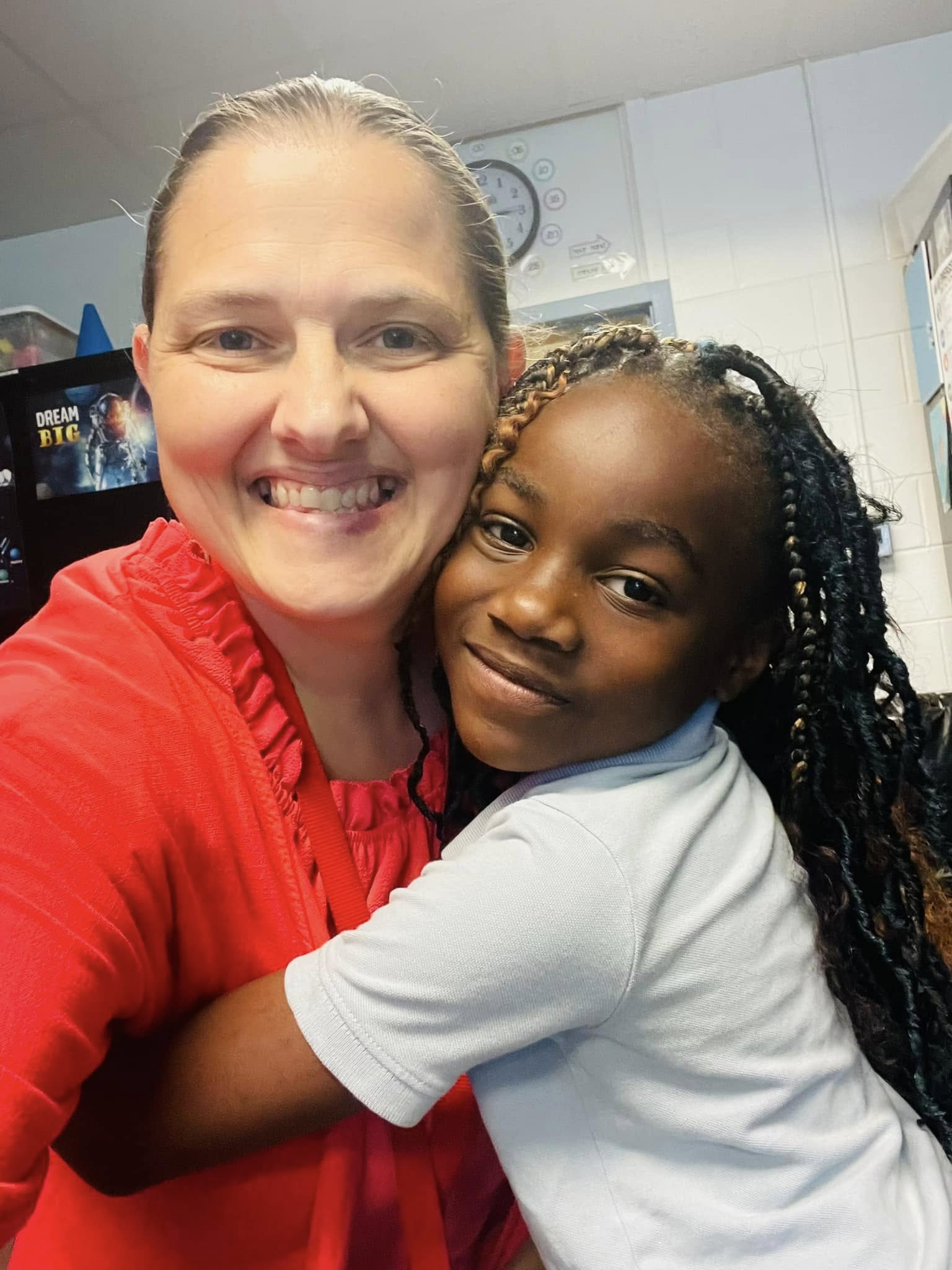 Kimberly with a young student in the classroom — a candid moment that captures the warmth and connection at the heart of her work.